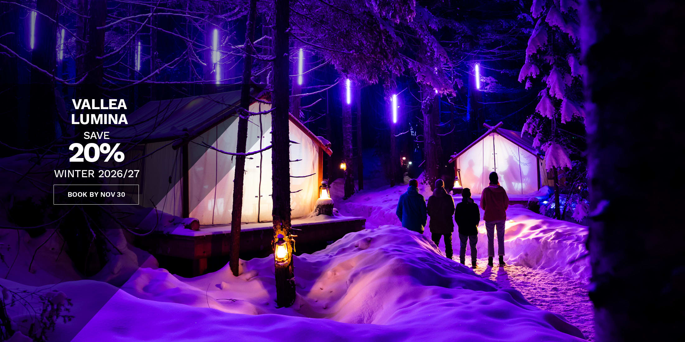 Vallea Lumina: save 20% on winter 2026/27 tickets when you book by Nov 30. Visitors walk a snowy forest trail in Whistler lit by glowing purple lights.