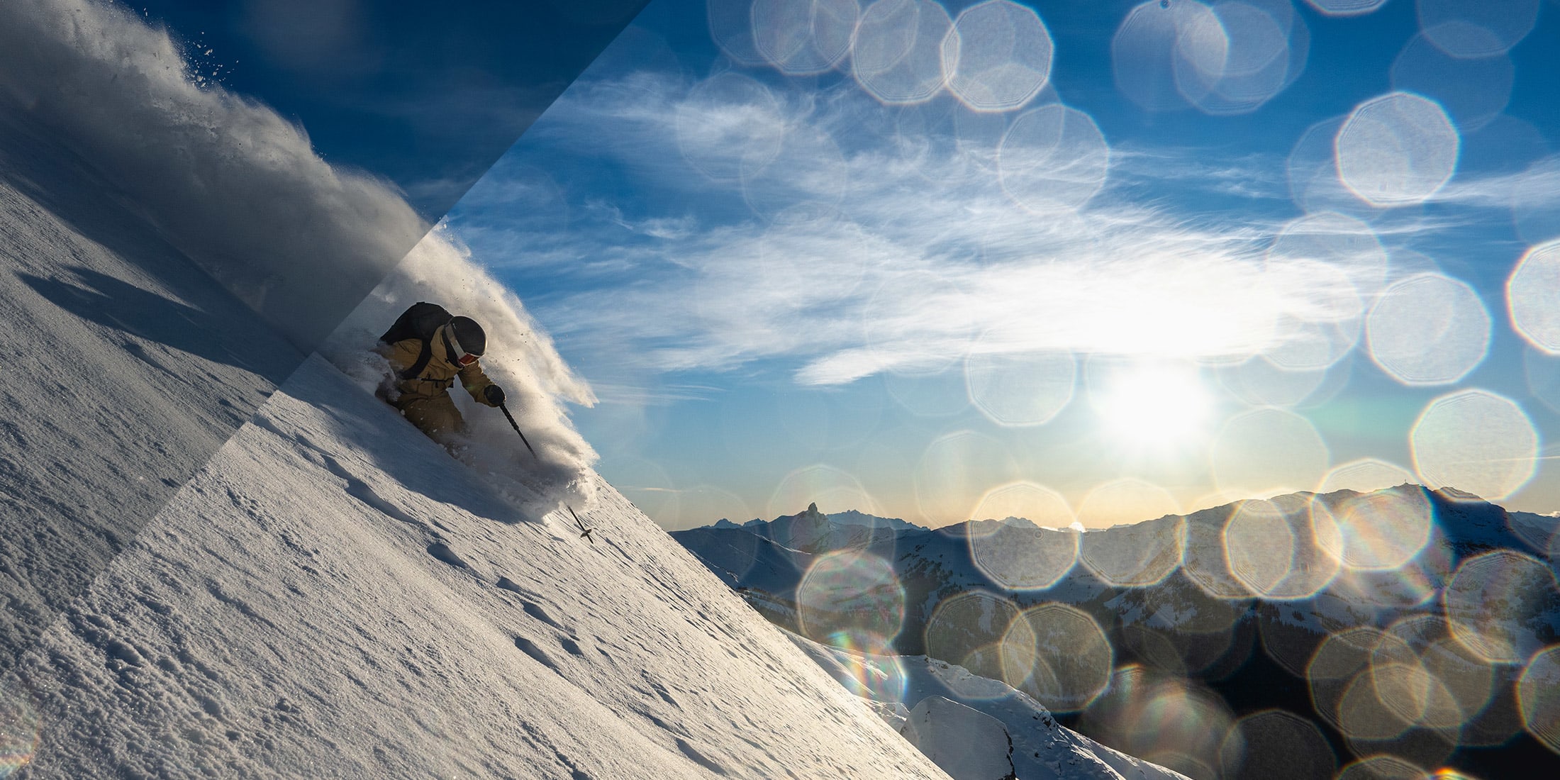 A skier enjoying powder on a steep slope in the sunshine at Whistler Blackcomb with Black Tusk in the background
