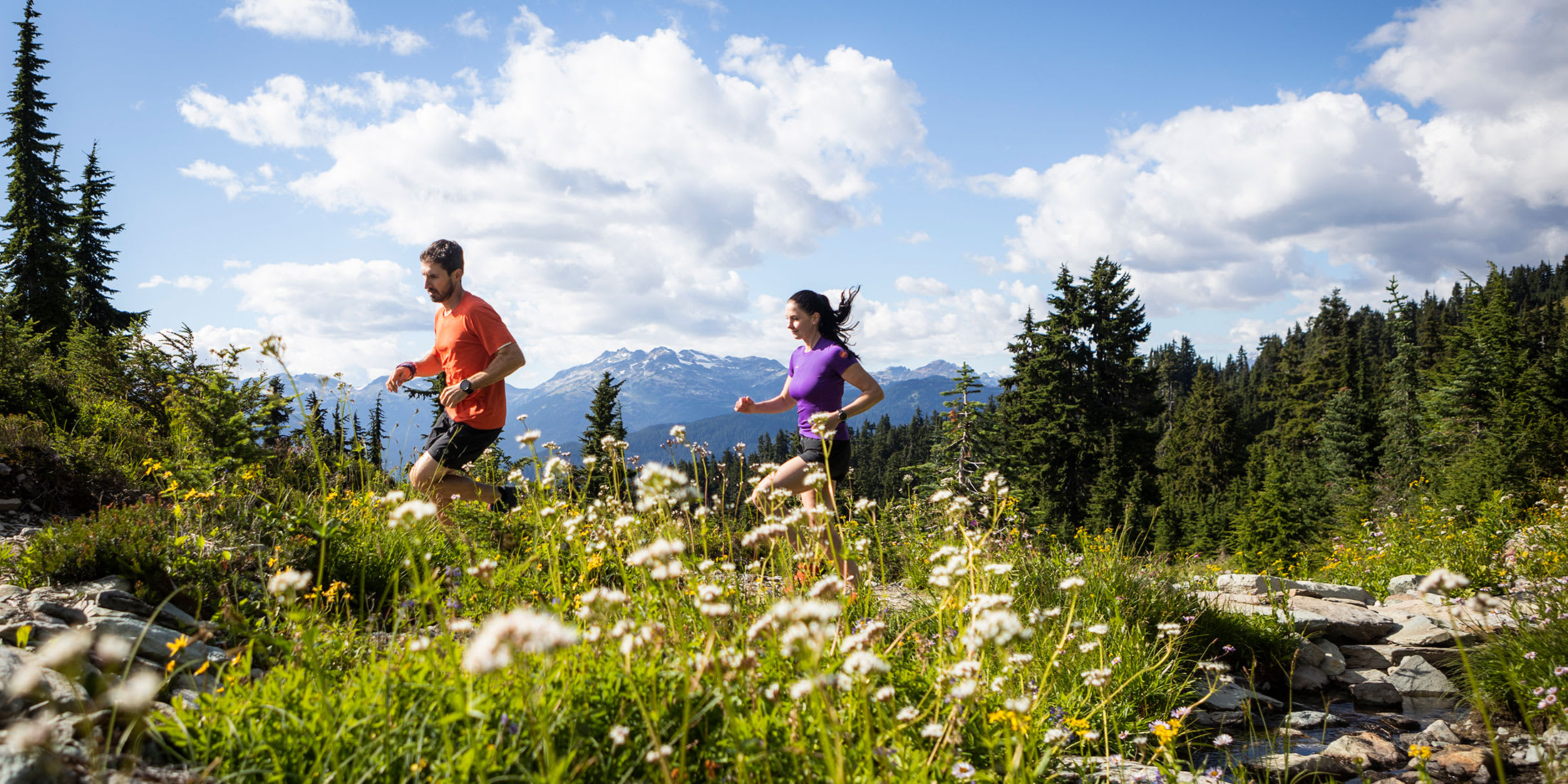 Two people running in the alpine at Whistler Blackcomb in British Columbia