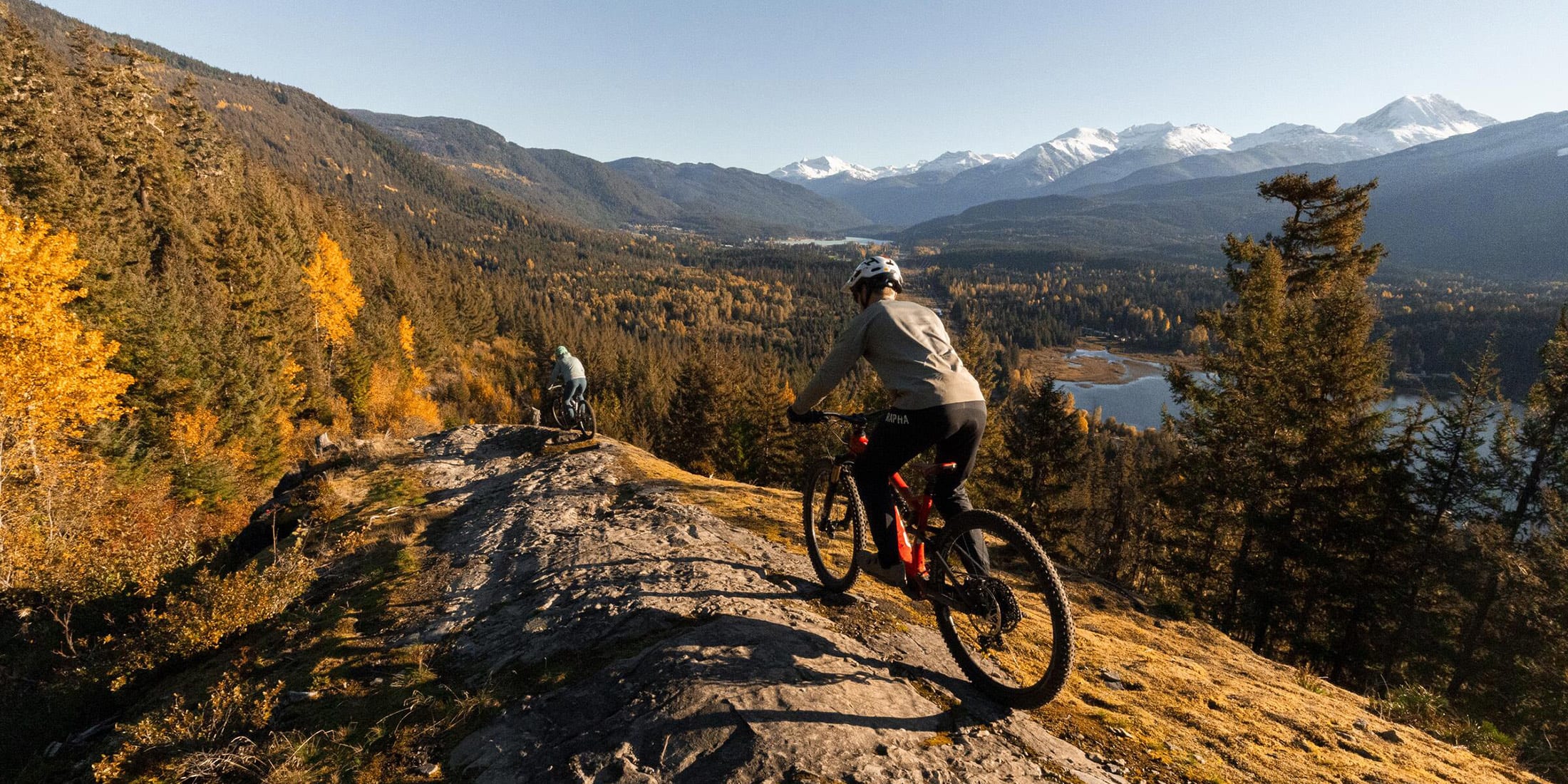 Two people fall trail riding on Enduro e-bikes on Beaver Pass in Whistler, British Columbia