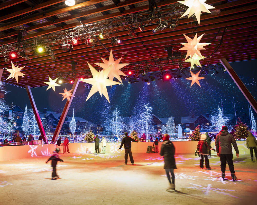People skating at the Plaza under the festive lights in wintertime