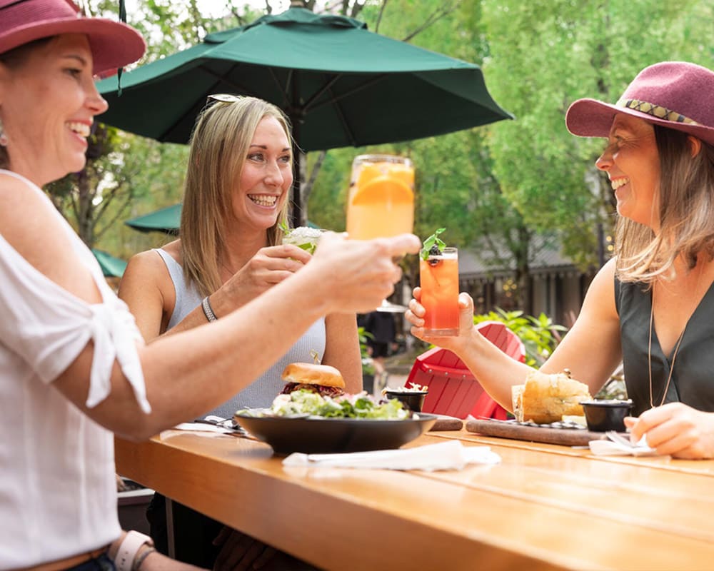 Friends dining at Portobello at Fairmont Chateau Whistler in Whistler's Upper Village