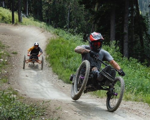 Two adaptive mountain bikers in the Whistler Bike Park