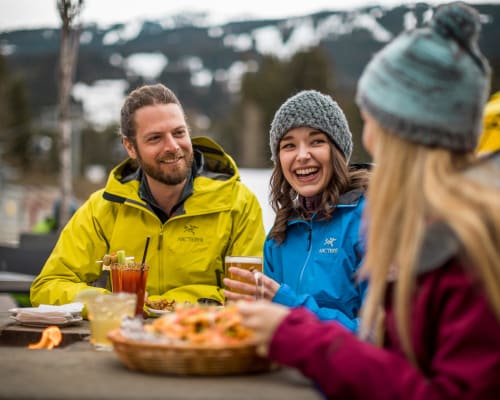 A group of people enjoying spring après on a patio