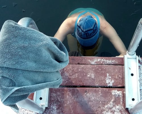 A person taking a cold-water plunge in a Whistler lake