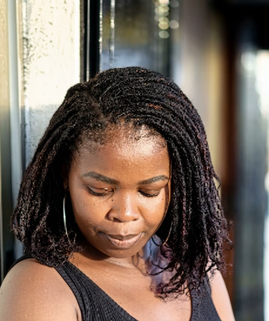 Human hair micro locs installation in progress at Fabz Hair, Nairobi