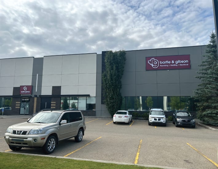 Another exterior view of the Edmonton South location for Bartle & Gibson, displaying the spacious parking lot and entry.