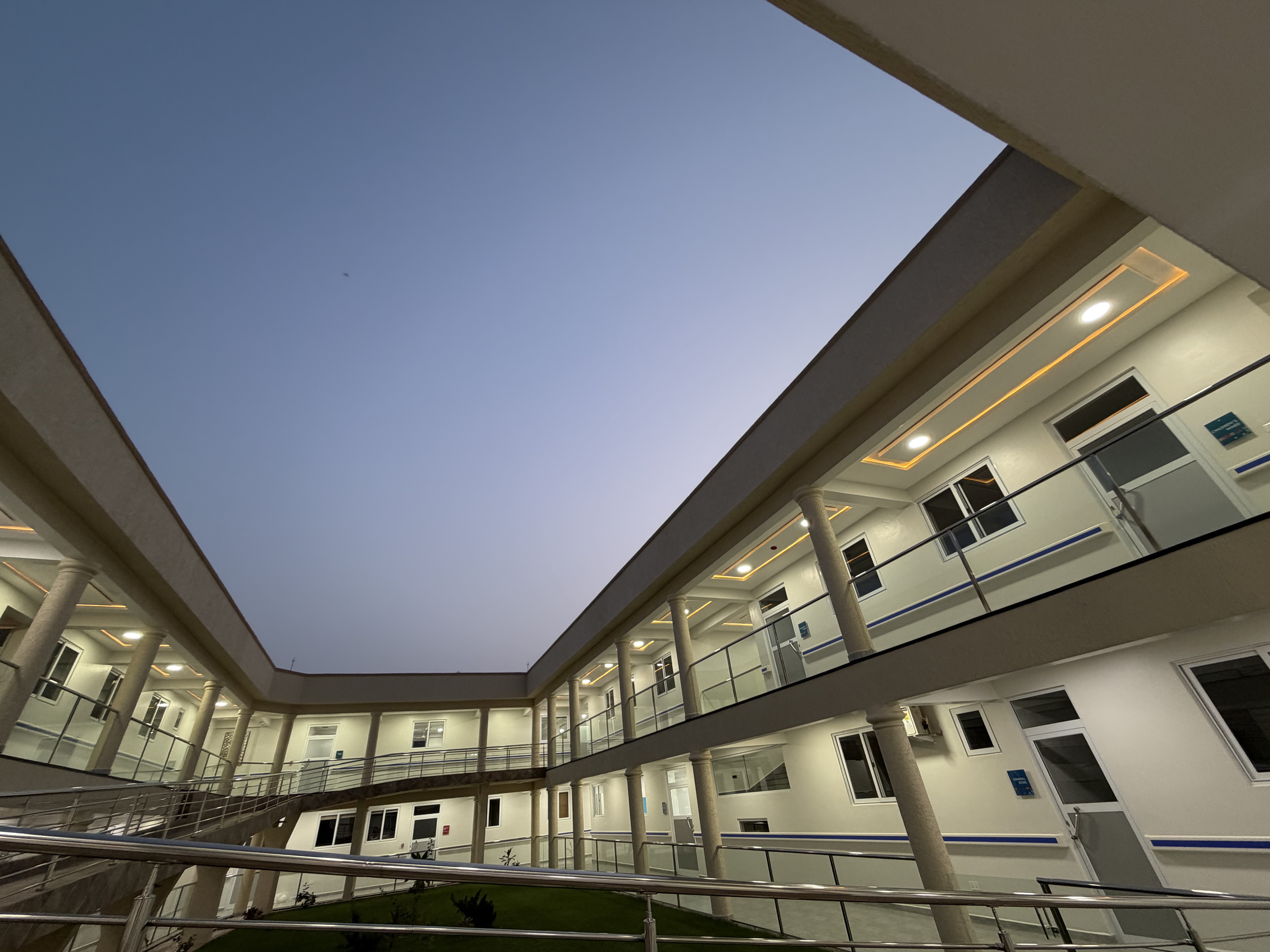 Modern hospital corridor with seating and clinical rooms