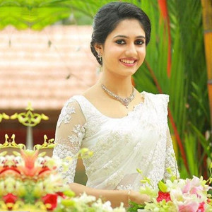 Christian Bride looking stunning in a Off-white saree and net sleeved blouse Christian Bride looking stunning in a Off-white saree and net sleeved blouse