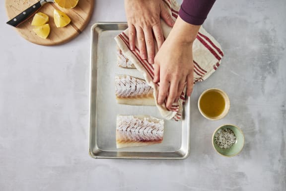 raw cod fillets on sheet pan