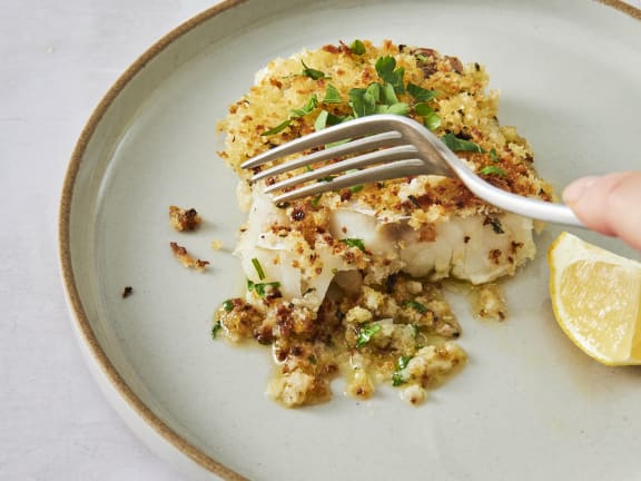 fork going into baked cod fillet