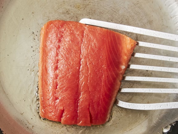 coho salmon frying in pan