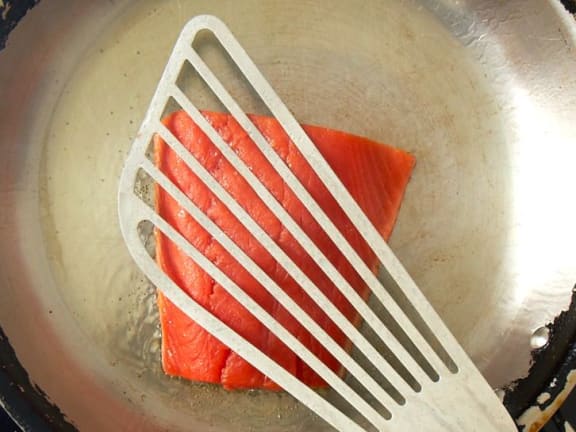 sockeye salmon frying in pan