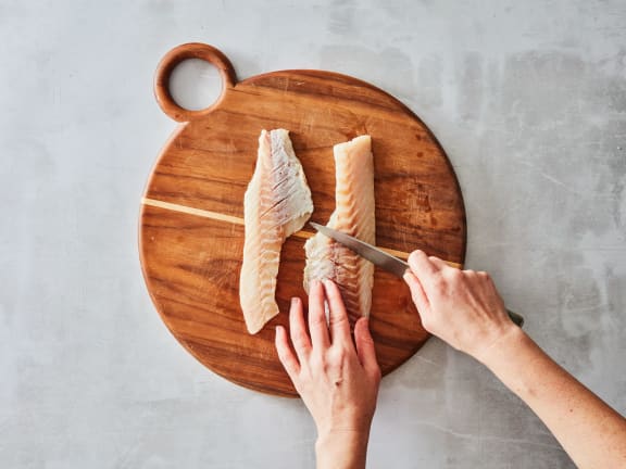 cutting raw rockfish fillets