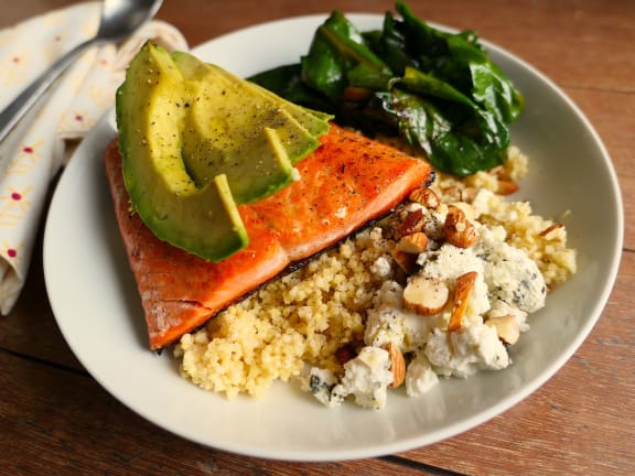 salmon goat cheese and almonds over quinoa in a serving bowl