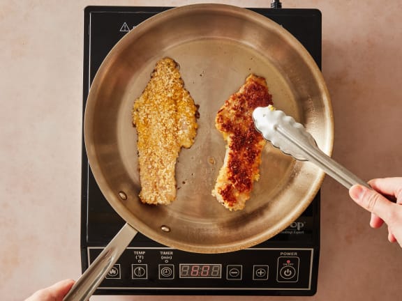 fried and breaded rockfish fillets in pan