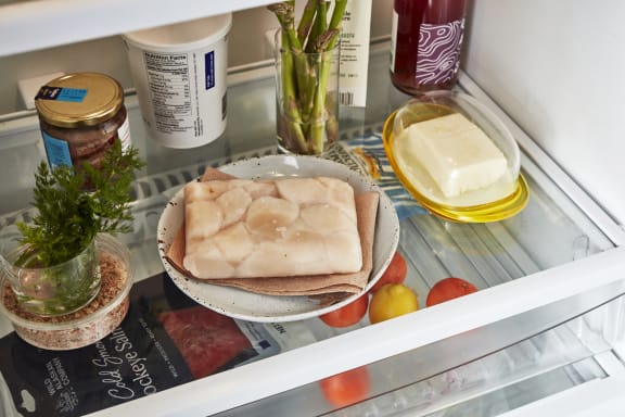 defrosting scallops on plate in freezer 