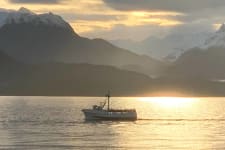 Alaskan fishing vessel on the water at sunset