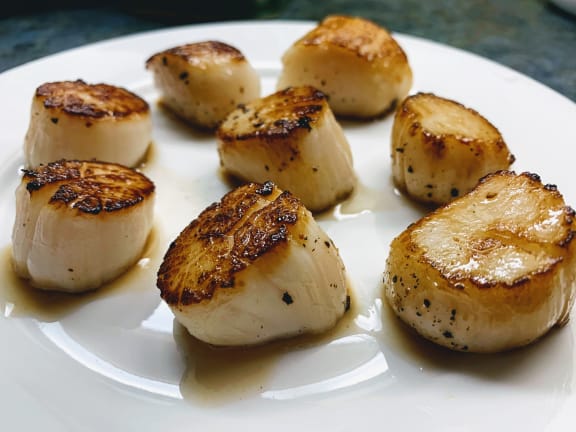 seared weathervane scallops on a plate