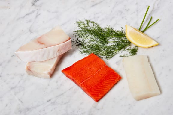 raw seafood fillets on marble