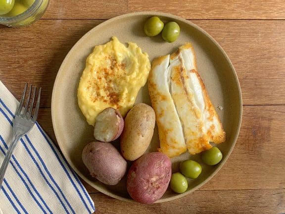 halibut fillet with boiled potatoes and olives