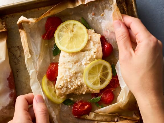 pacific cod fish en papillote with cherry tomatoes and herbs