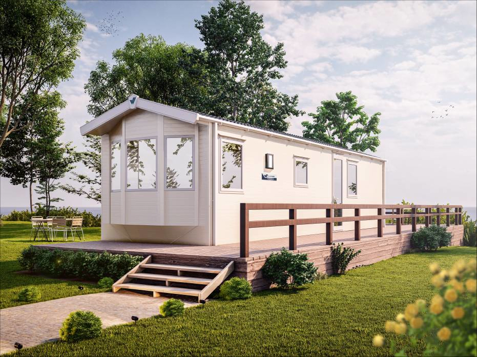 The Willerby Ashurst exterior in cream with brown decking sat on a grassy park.