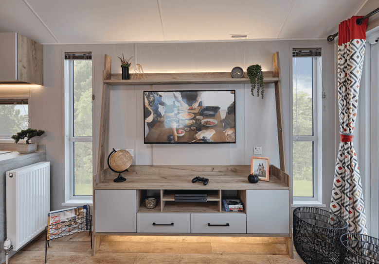 The Willerby Astoria media unit is an oak effect ladder style unit with white cupboard doors.