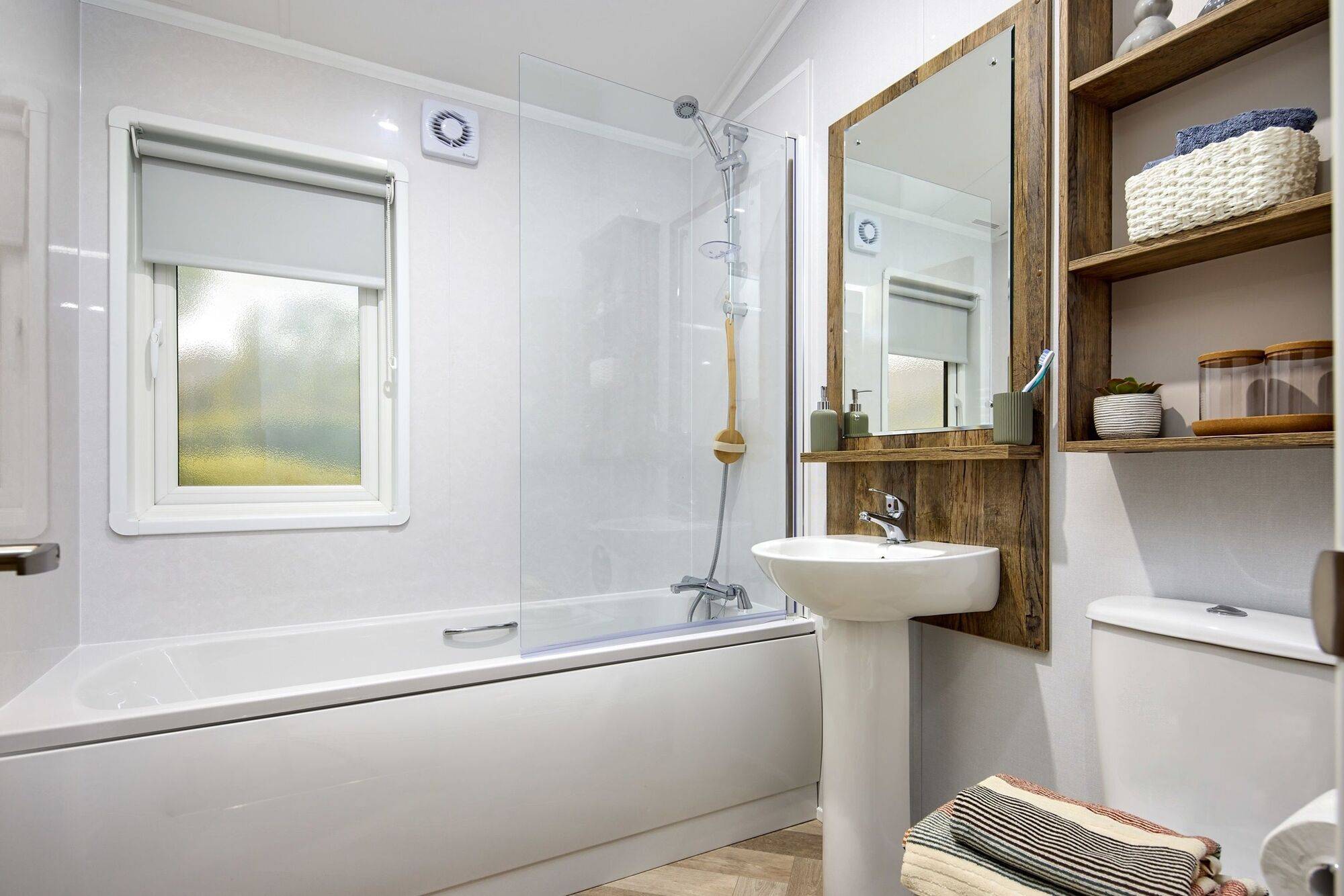 The Willerby Boston bathroom with dark oak effect units and an optional bathtub.