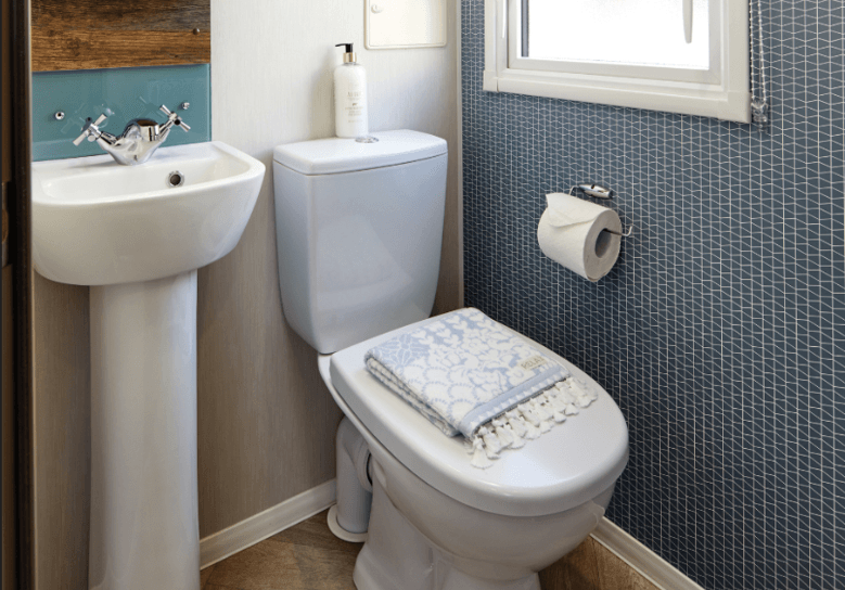 The Willerby Brookwood contemporary bathroom with a patterned feature wall and splashback.