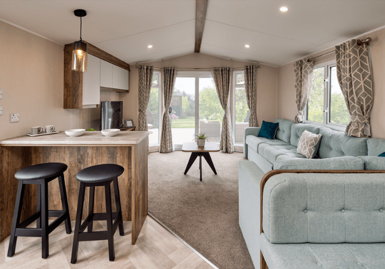 The Willerby Brookwood Breakfast bar with black stools and a dark oak effect table with white marble effect tabletop.