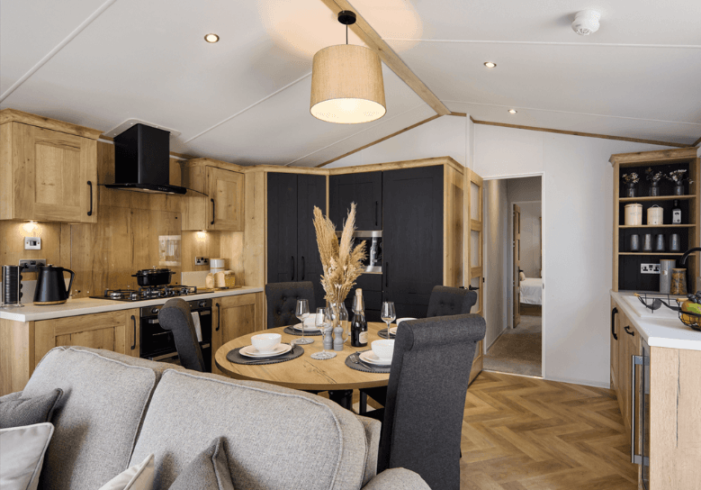The Willerby Dorchester luxurious kitchen with oak effect kitchen cabinets and black cupboard doors, and plenty of worktop space.