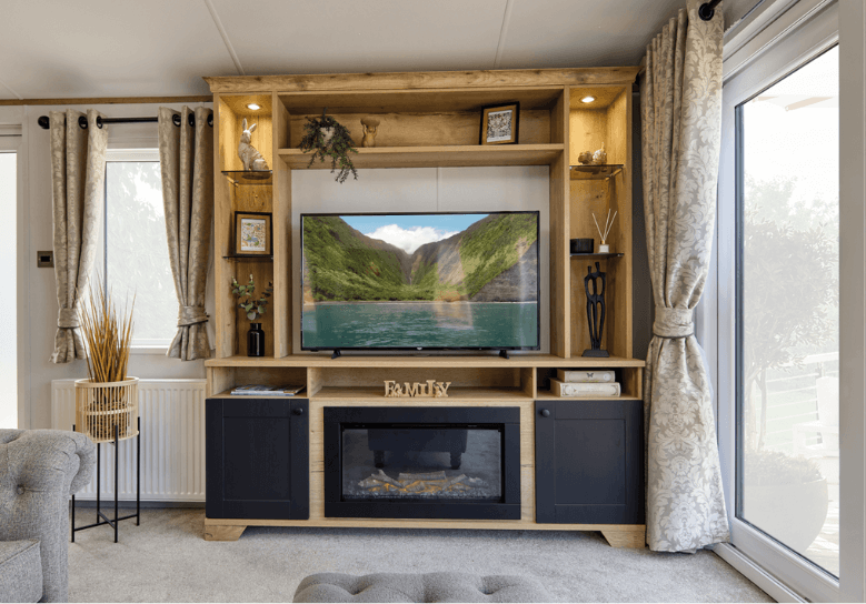 The Willerby Dorchester media unit oak effect unit with black cabinet doors. It provides extra storage to the home.