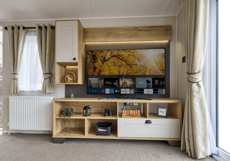 The Willerby Gainsborough oak effect media lounge with white accent doors, allowing for storage.