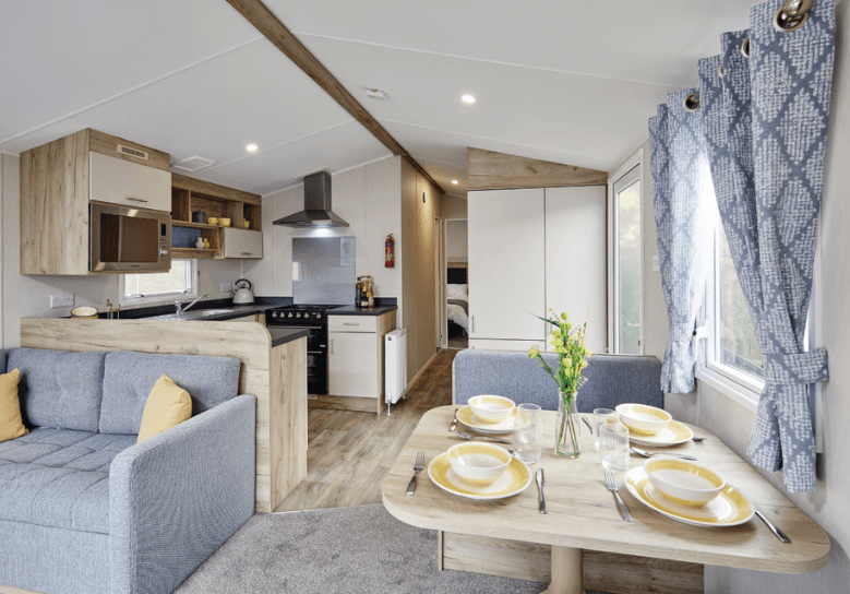 The Willerby Linwood dining area with two grey and oak effect seating and a matching oak effect table.