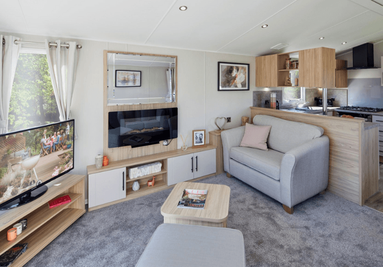 The Willerby Manor lounge has freestanding sofas with a matching footstool, an oak effect coffee table and a media unit.