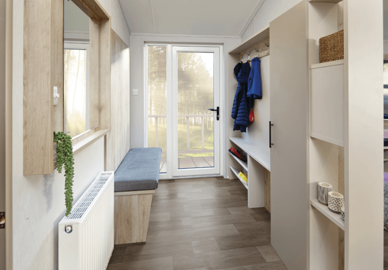 The Willerby Mapleton entrance has a fixed grey seating near the door with plenty of storage.