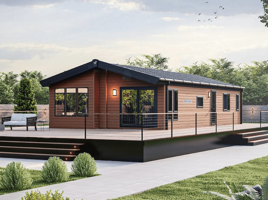 The Willerby Pinehurst exterior in brown on a brown decking, sited in a secluded and quiet area.