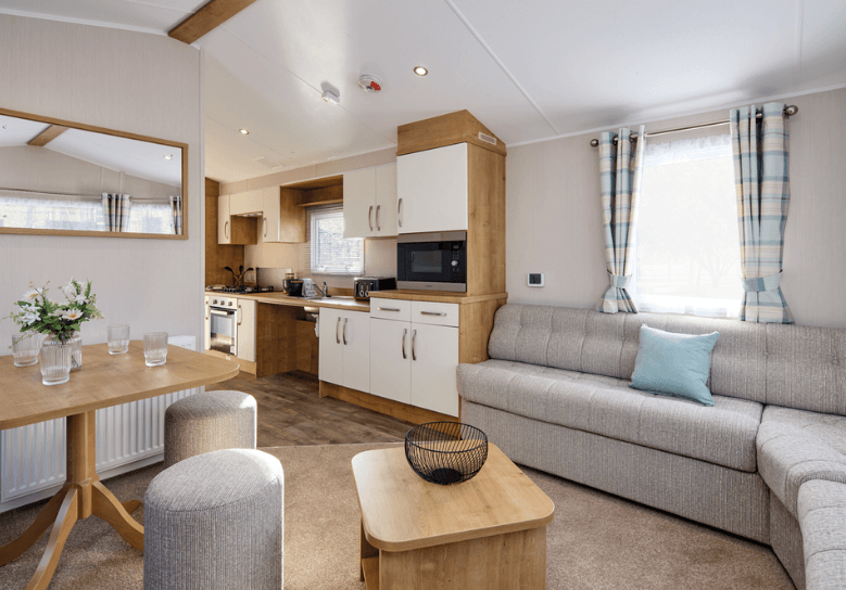 The Willerby Richmond oak effect dining table with two grey stools, matching the colour of the seating in the home.