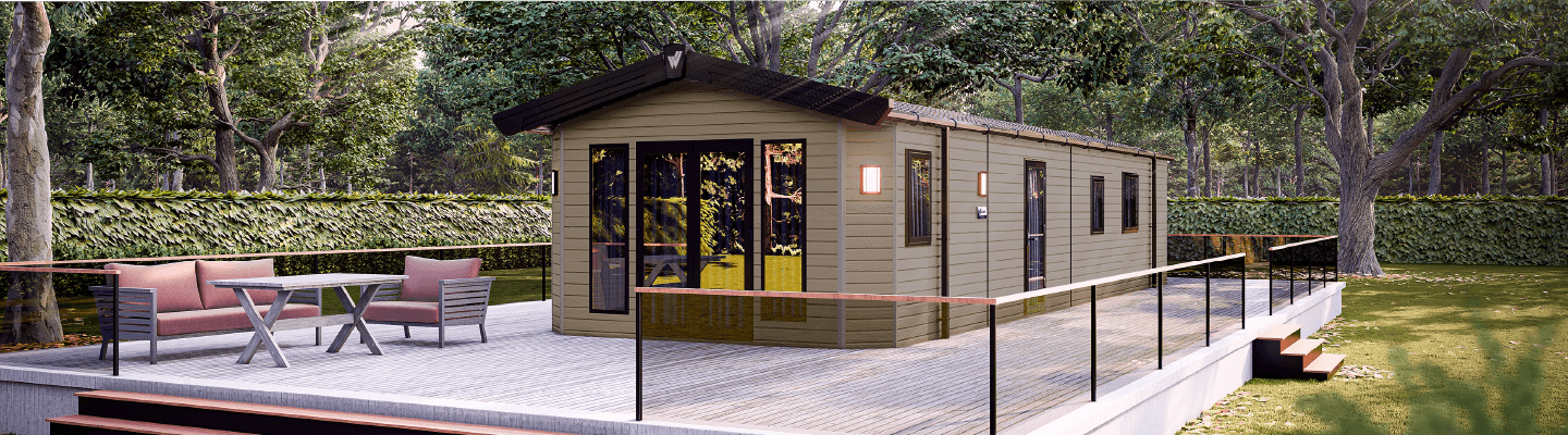 The Willerby Sheraton exterior in green with white decking sited on a cosy grassy forest.