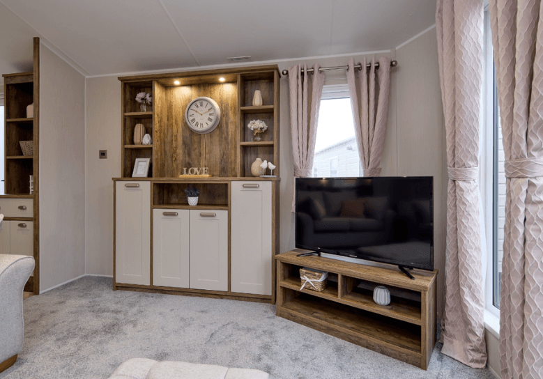 The Willerby Sheraton media lounge has oak effect storage units with white cupboard doors.