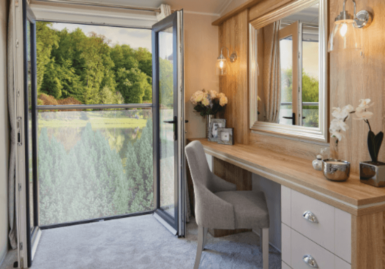 The Willerby Vogue Classique has a juliet balcony next to an oak effect dressing area.