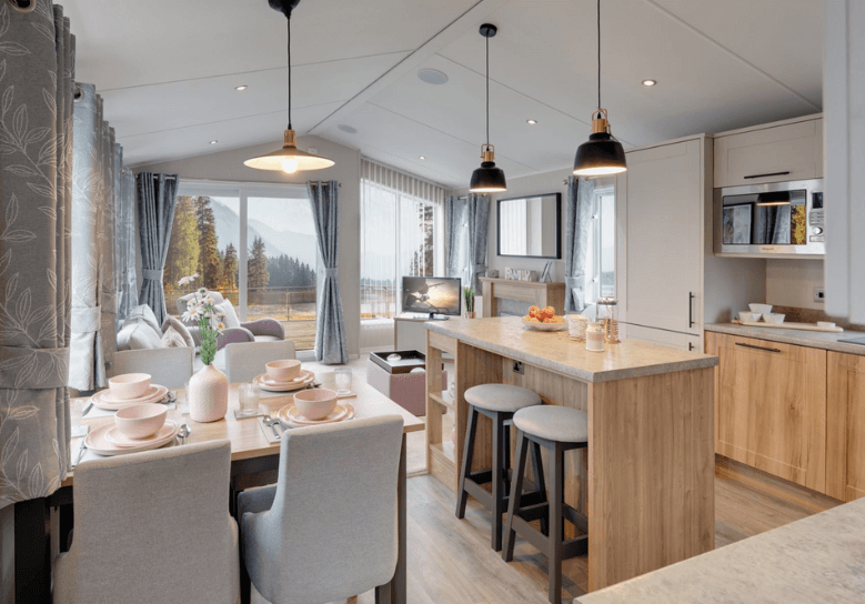 The Willerby Waverley kitchen has oak effect kitchen units with grey worktops and a matching kitchen island.
