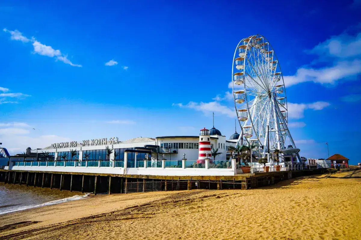 A Ferris wheel and funfair on the pier at Clacton in Essex. 