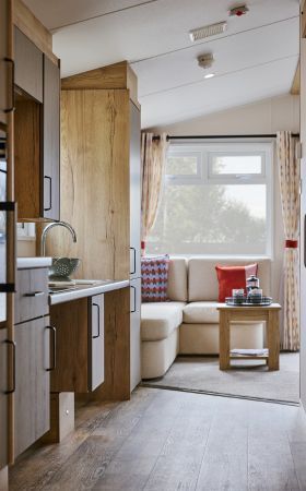 Willerby Rio Access holiday home galley kitchen leading to lounge.