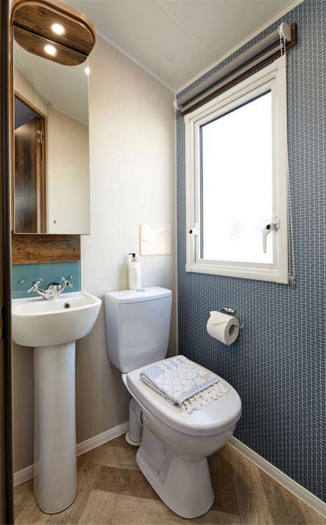 The Willerby Brookwood contemporary bathroom with a patterned feature wall and splashback.