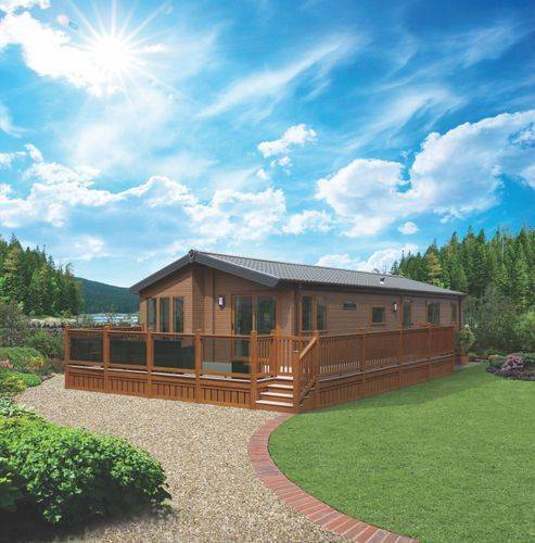 The Willerby Pinehurst exterior in brown on a brown decking, sited in a secluded and quiet area.
