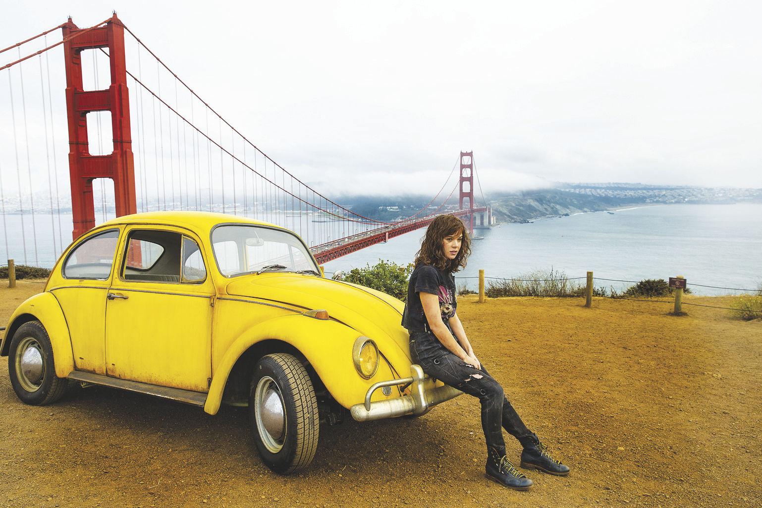 Bumblebee in his car form and Hailee Steinfeld as Charlie in "Bumblebee," the sixth film in the live-action "Transformers" franchise. (WILL MCOY/PARAMOUNT PICTURES)