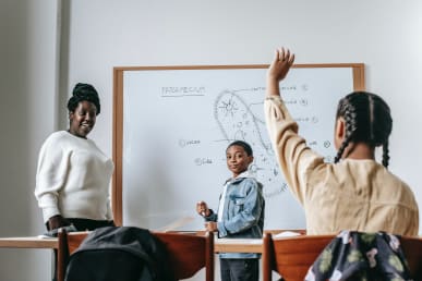 Woman and students during lesson; Photo by Katerina Holmes from Pexels