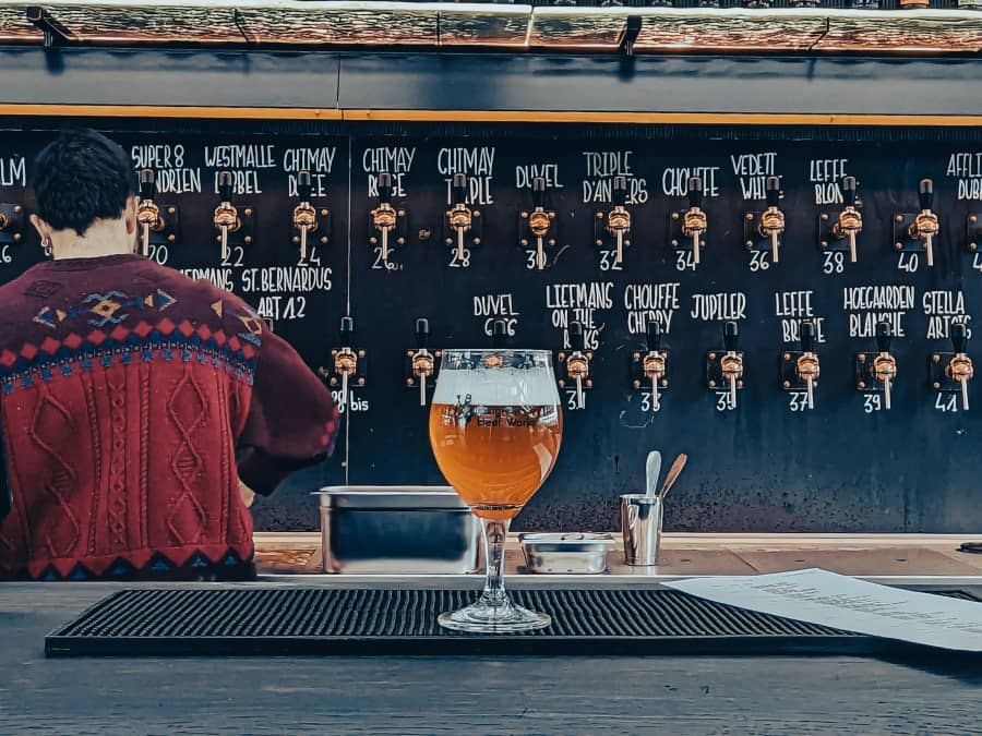 A wall of taps behind the counter of a bar
